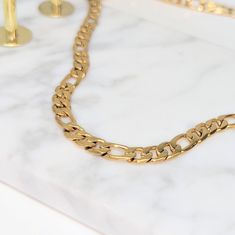 Our Kid's Statement Figaro Chain Necklace is the perfect statement piece. A Figaro chain necklace, made of stainless steel dipped in real 18k gold. It's hypoallergenic and waterproof, making it a perfect fit for the modern child (and their delicate skin). This versatile necklace can be dressed up or down, making it an ideal everyday piece. ✔ Hypoallergenic ✔ Waterproof ✔ Quality Guaranteed MATERIAL: ﻿Stainless steel dipped in real 18k gold Modern Cuban Link Necklace With Figaro Chain As Gift, Gift Cuban Link Necklace With Figaro Chain, Gold-plated Cuban Link Necklace With Figaro Chain For Gift, Tarnish Resistant Cuban Link Necklace Gift, Gold Stainless Steel Figaro Chain Necklace, Gold Stainless Steel Necklace With Figaro Chain, Tarnish-resistant Cuban Link Necklace Gift, Necklace For Kids, Gold Figaro Chain