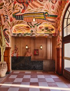 an ornately decorated lobby with checkered flooring and wooden paneled walls is pictured in this image