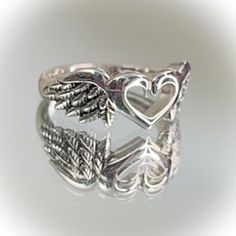 Beautiful Sterling Silver Heart With Wings Ring Available In Sizes 6, 8, 9 Top Of Ring Height: 8.6mm Band Width: 2.7mm Shank Width: 2.5mm Metal: 925 Sterling Silver Plating: Rhodium Plated Finish: High Polish Wlw Promise Rings, Darry Ring, Grunge Rings, Angel Rings, Alternative Rings, Silver Ring Stack, Grunge Ring, Cool Rings, Wings Ring