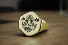 Embrace the blessings of Lord Ganesh with this exquisite hexagon-shaped gold signet ring, adorned with a detailed engraving of the revered Indian deity. Designed to combine spiritual symbolism with modern elegance, this custom ring serves as a unique statement piece. The hexagon shape adds a contemporary flair, while the bold Ganesh engraving ensures it stands out. Perfect for both men and women, this religious Hindu ring is a meaningful gift or a distinctive addition to your jewelry collection. Wear it daily or on special occasions to feel the divine presence and cultural heritage it embodies. 📏 Ring Size: Choose your preferred size from the drop-down menu. 💍 Signet Details: Signet Size: 16mm Signet Shape: Hexagon Metal Type (Main Photo): 14k Gold Filled - Other options available in the Dna Jewelry, Ring Indian, Indian God, Fancy Gifts, Gold Signet Ring, Custom Ring, Unisex Ring, Unique Handmade Jewelry, Hexagon Shape