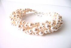 three stranded bracelet with pearls on white background