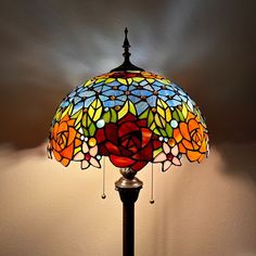 a stained glass lamp with roses on it