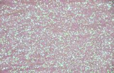 a pink glitter background with small white dots