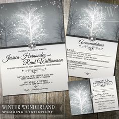 winter wonderland wedding stationery with silver and white snowflakes on the tree branches