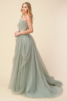 Andrea & Leo A1015 sage pleated drape ball gown. If you're a fan of Bridgerton, you'll be in the mood for spring garden hues like we are. This sage ballgown with delicate blossom details is made of beautifully draped plisse tulle that pleats over a nude corset bodice. Whispery yet regal, plisse tulle at skirt has underlayers with subtle sparkle that make this gown truly magical. The bodice has an adjustable corset back for a guarantee for all body types. Sage Prom Dress, Modest Prom Gowns, Andrea And Leo, Tulle Balls, Dress Layered, Corset Bodice, Tulle Ball Gown, Gowns Prom, Ball Gowns Evening