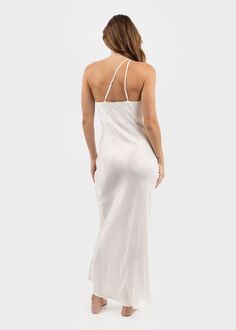 A piece from our Hera collection inspired by ancient Greece and Olympias, it delivers a modern take on traditional designs. A balance of comfort and shape, the Hera slip dress is crafted with clean lines and eco-certified fabrics. Designed with an asymmetric one-shoulder neckline, a fitted bodice and maxi length. Crafted 100 percent from our signature Vegan Cupro fabric for durability, and breathability. Made primarily from Bemberg®, a yarn fiber derived from a by-product of the cotton harvest, Elegant Slip Dress With Straight Neckline And Side Slits, Elegant Asymmetrical Spaghetti Strap Dress, One Shoulder Slip Dress For Summer, Summer One-shoulder Slip Dress, Elegant One Shoulder Summer Slip Dress, One Shoulder Bias Cut Slip Dress, Elegant One-shoulder Summer Slip Dress, One-shoulder Bias Cut Slip Dress, Spring One-shoulder Asymmetrical Dress With Bias Cut