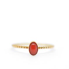 Stacking ring with coral, made of sterling silver with a coral stone. The stacking ring has a band of ball wire and is gold plated. The ring is custom made for you. Material: sterling silver, ring band 1mm Gemstone: Italian Coral, 4x6mm Trudi Phelka - Minimalist gold and silver jewelry Coral Engagement Ring, Coral Stone Ring, Black Beads Mangalsutra, Black Beads Mangalsutra Design, Coral Ring, Gold Ring Designs, Coral Stone, Coral Jewelry, Gold Jewelry Fashion