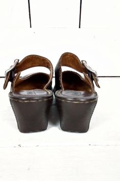 "Born brown leather mary jane wedge clog sandals/Born leather slip on mules/Born shoes/7/38 Measurements... - marked size: 7/38 - insole length: 9 3/8\" - width at ball: 3.25\" -heel: 2.5\" Features... -awesome dark brown leather...very soft and sturdy -adjustable buckle -super comfy rubber platform wedge soles -padded leather foot bed -label: Born Condition... -excellent condition -very gently worn -original box included 1N*" Leather Mary Jane Open Toe Sandals, Mary Jane Leather Sandals With Heel Loop, Leather Slip-on Wedge Sandals With Round Toe, Leather Mary Jane Sandals For Summer, Mary Jane Sandals With Leather Sole, Leather High Heel Mary Jane Sandals, Leather Mary Jane High Heel Sandals, Brown Wedge Sandals With Buckle Closure And Round Toe, Leather Wedge Heel Clogs With Buckle Closure