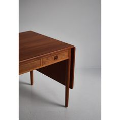 a small wooden table with two drawers on one side and an open drawer on the other