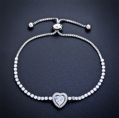 Delicate and elegant, this adjustable heart bracelet will add a touch of sophistication to any wedding gown or formal ensemble. Adorned with heart-shaped cubic zirconia that captures the light from every angle with a perfectly translucent appeal, the bracelet is rhodium / rose gold / yellow gold plated for a flawless finish which perfectly enhances the intricate detailing and conveys a modern take on old elegance. The bracelet measures 0.4" (approx. 1cm) at the widest point, and the adjustable c Crystal Double Heart Jewelry For Wedding, Wedding Jewelry With Heart Charm In Cubic Zirconia, Cubic Zirconia Heart Charm Jewelry For Wedding, Wedding Jewelry With Cubic Zirconia Heart Charm, Adjustable Heart-shaped Diamond Jewelry, Elegant Heart Charm Jewelry In Cubic Zirconia, Elegant Cubic Zirconia Jewelry With Heart Charm, Diamond Heart Bracelet For Wedding, Elegant Heart Charm Jewelry With Cubic Zirconia