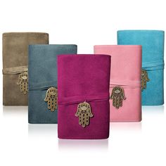 four different colored towels with hamsah charms on them