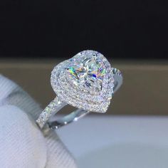 a cushion cut diamond ring with pave set shoulders