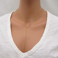 REAL GOLD-FILLED NECKLACE SET This lariat necklace set is made with all gold-filled parts (not plated) so it will be durable and tarnish resistant. Includes both necklaces pictured - can be worn together or separately. The drop chain of the lariat measures approximately 4 inches long. Please leave a note at checkout if you want this changed. Both necklaces close with a spring-ring clasp. Sterling silver version here: www.etsy.com/listing/763096037/sterling-silver-lariat-necklace-layering SIZING - PLEASE READ: Note that necklaces will fit differently depending on a person's size. Please measure. ABOUT GOLD FILLED JEWELRY: This quality piece is made with real gold filled, not plated. Gold-filled jewelry has 100x more gold alloy than gold plated and because that layer is so much thicker, it m Gold-plated Lariat Necklace With Gold Chain, Gold Lariat Jewelry With Delicate Chain, Adjustable Gold Layered Necklace As A Gift, Gold Chain Lariat Necklace For Gift, Lariat Gold Chain Necklace For Gift, Adjustable Gold Lariat Necklace For Layering, Gold Dangle Chain Necklace For Layering, Gold Drop Necklace With Adjustable Chain For Layering, Gold-plated Lariat Necklace As A Gift