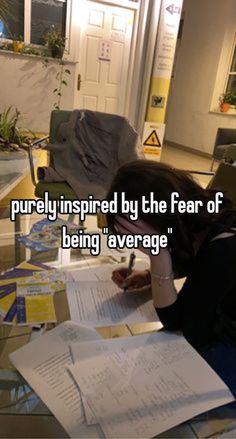 a woman sitting at a table with papers and pens in front of her, the caption reads i'm purely inspired by the fear of being average