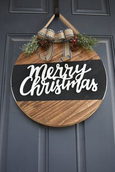 a merry christmas sign hanging on the front door