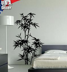 a bed room with a neatly made bed and a wall sticker