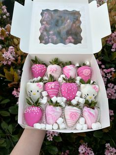 hello kitty chocolate covered strawberries in a white box with pink and white designs on them