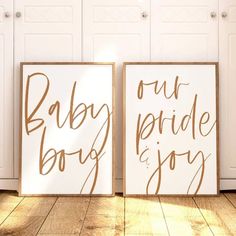 two wooden signs that say baby, our pride and joy on the floor next to each other