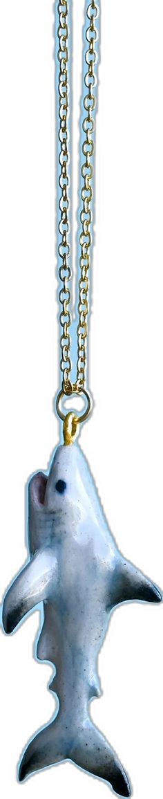 a silver and gold necklace with a white dolphin on it's back drop chain