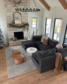 a living room filled with furniture and a fire place next to a window covered in christmas decorations