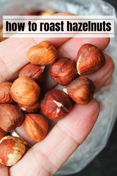 someone holding some nuts in their hand with the words how to roast hazelnuts