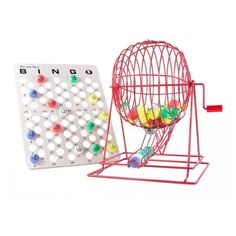 a red cage with balls in it next to a board game