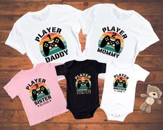 "NOTE: The shirts must be added to cart separately and check out together. Thank you Daddy and me Gamer Matching Shirt fits like a well-loved favorite. Super soft cotton and excellent quality print make one to fall in love with it over and over again. Daddy and me Gamer Matching Shirt, Player 1 Player 2 matching Shirt, Fathers Day Gift, Pregnancy Reveal Tee, Gamer Family Matching, Dad Son Kids will love this custom youth short sleeve tee. This lightweight (4.0 oz) side-seamed shirt maximizes com Family Matching Cotton Shirt For Playtime, Family Matching Cotton Shirt For Gender Reveal, Family Matching Shirts, Player 1, Dad Son, Pregnancy Reveal, Pregnancy Reveals, Shirt Fits, Matching Games