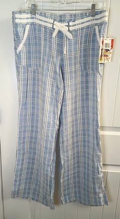 These JOLT women's pants are a stylish addition to your wardrobe. The blue striped linen blend fabric has a tasseled drawstring closure and wide-leg style that is perfect for a casual beachy look. The pants come with pockets and are machine washable for easy care. Ideal for summer and spring, these pants are available in a regular size with a waist of 35 inches and inseam of 31 inches. The flat front and low-rise waist make it comfortable and flattering for any body type. Perfect for a day at th Casual Striped Wide Leg Pants For Vacation, Summer Linen Striped Bottoms, Casual Striped Pants For The Beach, Casual Striped Wide Leg Loungewear Pants, Cotton Wide Leg Pants With Pockets For Beach, Casual Striped Wide Leg Lounge Pants, Striped Linen Pants For Loungewear, Striped Wide Leg Pants With Elastic Waistband For Vacation, Vacation Striped Wide Leg Pants With Elastic Waistband