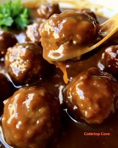 a spoon full of meatballs and gravy