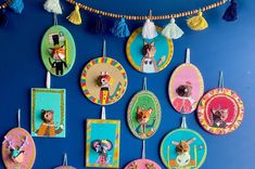 there are many plates hanging on the wall with pictures and tassels around them