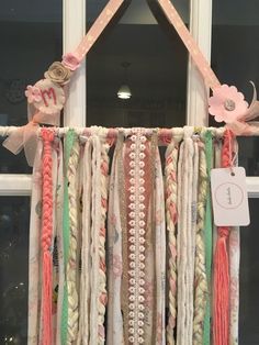 an assortment of ribbons hanging from a window