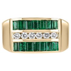 A mens' emerald and diamond channel set band. This band features natural baguette-cut emeralds and brilliant round diamonds. Each emerald has been meticulously hand-selected to ensure maximum quality. The smooth band is wide and comfortable for daily wear. Setting: Channel Set Metal Purity: 14K Yellow Gold Weight: 10.0 Grams Main Stone: Emerald Shape: Emerald Cut Total Emerald Weight: 1.60-Carats Clarity: Transparent Color: Green Luster: Very Good Cut: Excellent Origin: Zambia Secondary Stone: Diamond Total Diamonds: 6 Shape: Brilliant Round Total Diamonds Weight: 0.24 points Clarity: VS-SI Color: H-I Luster: Excellent Cut: Excellent Treatments: Natural Pave Ring Band, Mens White Gold Rings, Yellow Gold Mens Rings, Channel Set Rings, Green Emerald Ring, Tanzanite Diamond Ring, Three Stone Diamond, Mens Engagement, Men Diamond Ring