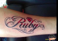 a tattoo with the word ruby written in cursive writing and a diamond on it