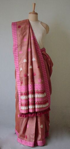 A genuine handloom product from the looms of Assam, India. The Sari has  mulberry silk in the warp and Tassar silk in the weft and the interweaving motifs in Cotton and acrylic Tassar Silk is a variety of wild silk found in the central Indian states of Chattisgarh , Jharkhand and Orissa. The yarns naturally occurs in soft beige to light brown colours. In this case , we have used dyed tassar silk yarns in the weft.  The tassar yarns gives the saree a crisp fall .  The sari is very soft , light  a Pink Bohemian Pre-draped Saree For Festivals, Festive Pre-draped Saree With Weaving Work, Bohemian Handloom Pre-draped Saree, Festival Art Silk Handloom Pre-draped Saree, Diwali Slub Silk Pre-draped Saree With Weaving Work, Diwali Raw Silk Pre-draped Saree With Weaving Work, Bohemian Style Pre-draped Raw Silk Saree, Handloom Slub Silk Pre-draped Saree For Diwali, Semi-stitched Slub Silk Handloom Pre-draped Saree