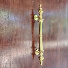 an old fashioned wall mounted phone on a wooden paneled door with metal handles and knobs