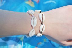 These beach inspired cowrie shell bracelets are a huge staple in summer style! This bracelet comes in two colors! You can choose white or black string for your bracelet! The length s 6 inches around and has a 2.5 inch adjustable string extender on each side on the shells. You can stack these adorable bracelets with other stylish designs I sell in my shop. Summer Strand Friendship Bracelets, Summer Festival Strand Bracelets, Summer Festival Strand Bracelet, Summer Friendship Bracelets In Strand Shape, Bohemian Bracelets For Friendship In Summer, Summer Festival Beaded Bracelets, Bohemian Friendship Bracelets For Summer Vacation, Summer Beachy Friendship Bracelets, Beachy Friendship Bracelets For Summer