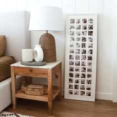 a living room with a couch, table and pictures on the wall next to it