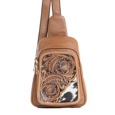 Elevate your style with the Myra Bag Kelzer's Creek Hand Tooled Leather Sling Bag. This stunning accessory showcases a rich blend of caramel and bourbon hues, exuding a sophisticated allure. Handcrafted from premium leather, it features a meticulously hand-tooled Western foliage pattern and a unique inset of hair-on hide that adds an extra touch of charm. Designed with both form and function in mind, the Kelzer's Creek Sling Bag offers ample space with its zippered compartments to keep your esse Cognac Saddle Bags With Adjustable Strap, Brown Rectangular Chest Bag With Adjustable Strap, Brown Rectangular Chest Bag With Removable Pouch, Brown Saddle Shoulder Bag With Removable Pouch, Brown Leather Chest Bag With Adjustable Strap, Brown Leather Satchel Chest Bag, Brown Satchel Chest Bag With Removable Pouch, Brown Leather-backed Crossbody Chest Bag, Brown Leather-backed Chest Bag For Daily Use