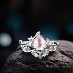 a pink ring sitting on top of a rock