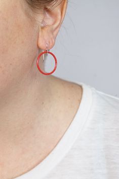 These lightweight circle earrings are sure to become your new favorite pair. An update on classic hoops, each circle retains evidence of their making - a small dot marks the spot where I hand-weld each earring. Approximately 1 1/4" tall (including ear wires) and 7/8" wide. Powder coated in a bright red color. Sterling silver ear wires. Handcrafted in my Pennsylvania studio. Ships in 1-2 business days. Comes in a gift box. Treat yourself or a loved one! Small Red Hypoallergenic Hoop Earrings, Minimalist Red Round Earrings, Red Circular Jewelry For Gifts, Red Circle Jewelry For Gift, Red Adjustable Hypoallergenic Hoop Earrings, Modern Red Hoop Earrings, Red Sterling Silver Hoop Earrings, Red Hoop Jewelry For Everyday, Red Sterling Silver Round Hoop Earrings