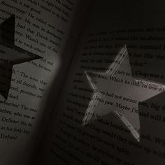 an open book with two stars cut out of it