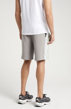 PUMA and LA-based label PLEASURES collaborate on these comfy cotton French terry sweat shorts done in a cool colorblock style with neon trim. 8" inseam; 25" leg opening; 13" front rise; 16 1/2" back rise (size Medium) Elastic/drawstring waist Front welt pockets 70% cotton, 30% recycled cotton Machine wash, tumble dry Imported PUMA has received the Fair Labor Association accreditation, which signifies that the company has effective systems and procedures in place to successfully uphold fair labor standards throughout its supply chains, including strategies and tools to address and improve working conditions Sporty Cotton Shorts For Leisure, Athleisure Cotton Shorts For Leisure, Cotton Athleisure Shorts For Leisure, Sporty Cotton Athletic Shorts For Leisure, Cotton Athleisure Athletic Shorts For Loungewear, Cotton Sportswear Shorts For Leisure, Cotton Athletic Shorts With Side Pockets For Loungewear, Relaxed Fit Cotton Sportswear Shorts, White Casual Athletic Shorts With Side Pockets