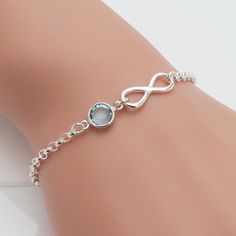 "Our sterling silver infinity bracelet includes a Swarovski birthstone of your choice. The bracelet has an extender chain making is adjustable between 6 1/2\" and 8\" Components: * swarovski birthstone crystal with silver plated frame - 7mm * sterling silver infinity charm * sterling silver chain Note: January and July birthstones are both dark red/siam ♥♥ all 'sentiments by rose & raven' pieces are gift boxed - perfect for gift giving! ♥♥ -------------------------------------------------------- Personalized Silver Bracelets, Silver Infinity Bracelets, Silver Bracelet Designs, Hand Jewelry Rings, Valentines Bracelets, Latest Bracelets, Horseshoe Pendant, Chain Making, Infinity Charm