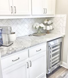 a kitchen with white cabinets and marble counter tops is featured in the magazine butter'n pantry