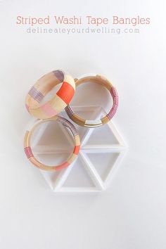 two wooden bangles sitting on top of each other in front of a white background