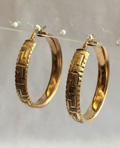 These vintage hoop earrings are 14K gold. Their total weight is 7.76 grams and they are 1.5 inch in diameter. The band is .25 inch wide with an attractive design. These earrings for pierced ears have a latch back. Classic Yellow Gold Hoop Clip-on Earrings, Classic 14k Stamped Hoop Earrings, Formal Hoop Earrings Hallmarked, Formal Hallmarked Hoop Earrings, Anniversary Yellow Gold Hinged Hoop Earrings, Formal Gold Hinged Hoop Earrings, Formal Gold Hinged Earrings, Formal Hoop Clip-on Earrings Tarnish Resistant, Formal Tarnish Resistant Hoop Clip-on Earrings