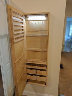 an open wooden cabinet with drawers in a room