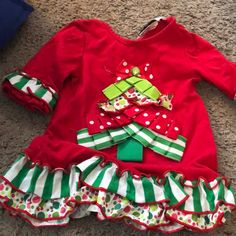 Like New, Washed But Never Worn, No Flaws, Smoke-Fee Home Long-Sleeved Christmas Top With Funky Mixed Prints, Ruffles, And Textured Christmas Tree Design Size 18 Months Playful Long Sleeve Holiday Tops, Green Ruffled Winter Tops, Winter Green Ruffled Tops, Green Ruffled Tops For Winter, Cute Red Holiday Tops, Playful Red Christmas Tops, Cute Long Sleeve Tops For Festive Occasions, Playful Cotton Holiday Tops, Playful Cotton Tops For The Holiday Season