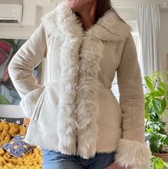 Elevate your style with our collection of Women's Penny Lane Coats and Jackets, inspired by the iconic Boho Hippie fashion of the 90s. Crafted with premium materials like fur, shearling, wool, and suede leather, our Penny Lane designs offer timeless elegance and cozy warmth. From the classic short body Afghan coat to the chic white variations, our range caters to every preference. Embrace the spirit of vintage fashion with our versatile selection, perfect for adding a touch of retro charm to any Short Afghan Coat, Winter White Outerwear With Faux Fur Lining, Winter Leather Jacket With Faux Fur Lining, Fitted Winter Outerwear With Faux Fur Lining, Fitted Outerwear With Faux Fur Lining For Winter, Trendy Long Coat With Faux Fur Trim, Winter White Long Sleeve Outerwear With Faux Fur Lining, Fitted Fur Coat For Cold Fall Weather, Winter White Outerwear With Faux Fur Trim