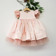 "This beautiful dress in blush pink is made for first birthday celebration, wedding parties, smash cake photoshoot and other formal events. We make dresses in standard sizes and by individual measurements. If your measurements differ from those below please send us your measurements in order note. Always feel free to contact us if you have any questions! SHIPPING We ship worldwide. Processing time for making your order is 3-5 business days. Standard USPS shipping takes 12-16 days, upgrade (expre Summer Princess Baptism Dress With Short Sleeves, Summer Princess Style Baptism Dress With Short Sleeves, Elegant First Birthday Tulle Tutu Dress, Short Sleeve Tulle Baptism Dress For Party, Tulle Dress With Flutter Sleeves For Party, Blush Tulle Dress With Ruffles, Short Sleeve Princess Dress For First Birthday In Spring, Elegant Spring Tutu Dress For First Birthday, Elegant Pink Tutu Dress For First Birthday